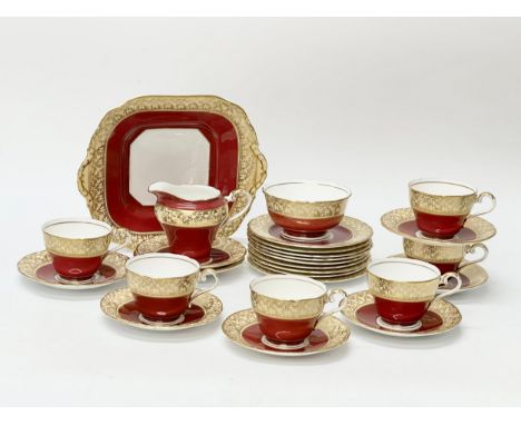 An Aynsley Fine Bone China tea service. Pattern 163 Burgundy &amp; Gold. Mid 20th Century. 26 piece.