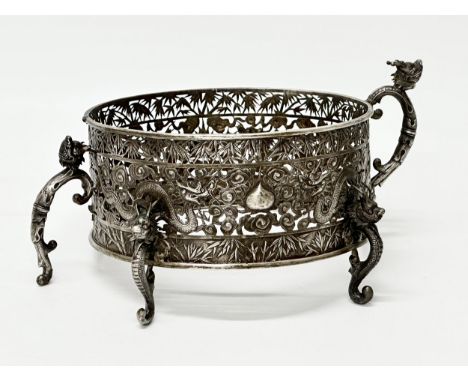 Wang Hing. A Chinese Export silver bowl. Late 19th/Early 20th Century. With pierced frame, dragon feet and looped handles. Wa