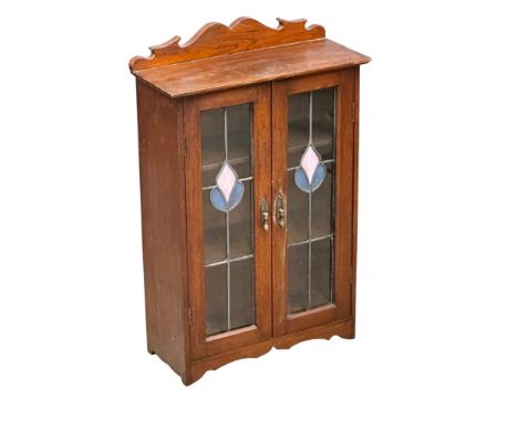 A walnut tabletop cabinet. C.1890. Late Victorian. With stained glass doors and fitted shelves. 43.5x19x68cm