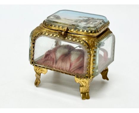 A Late 19th Century French gilt brass jewellery casket. With 5 bevelled panels and French street scene. 7x7x7.5cm