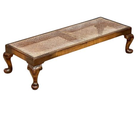 A long 1930’s footstool, with bergere top and Queen Anne legs. 101x40x23cm.