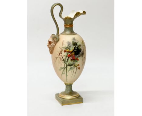 A Royal Worcester hand painted ewer vase. C.1900. With satyr mask on a looped handle, and hand painted floral sprays on a blu