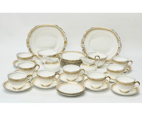 A New Chelsea Empire style tea service. C.1930. Early 20th Century. 36 piece. Two cake plates, 2 milk jugs, 2 sugar bowls. 9 
