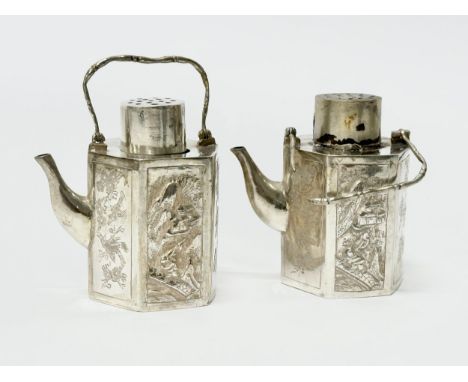 Chinese export silver salt and pepper shakers. Stamped SS. 19th Century. In the form of teapots, each with embossed and engra
