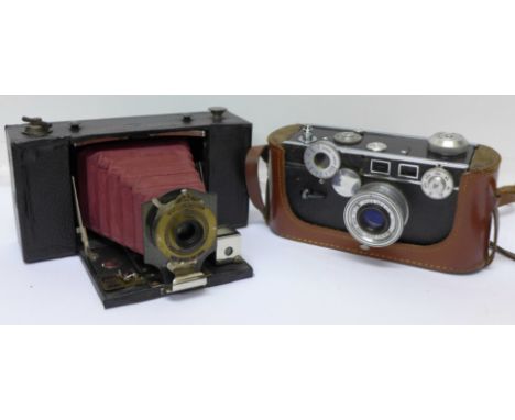 An Argus C3 35mm camera and a No. 3A folding Brownie camera with cases