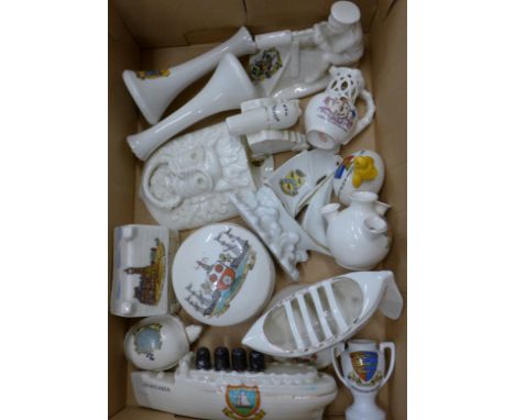 A collection of crested ware including The Lusitania, Tommy And His Machine Gun and a Goss wall pocket