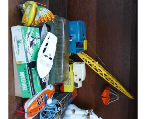 A collection of toys including Electric Aquaplane, Japanese tin plate speedboat, Tri-ang Minic ambulance, Gama crane, Mettoy 