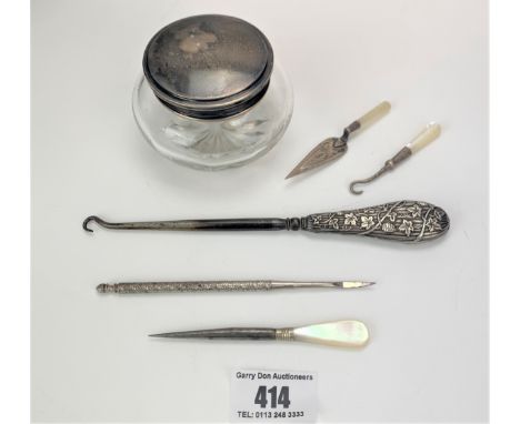 Assorted silver items – silver lidded glass jar, silver handled button hook, 3 mother of pearl handled tools and metal tool