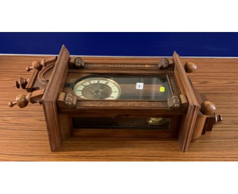 Wall clock with 2-hole brass/enamel face. With pendulum. 25”l x 11.5”w x 6.5”d