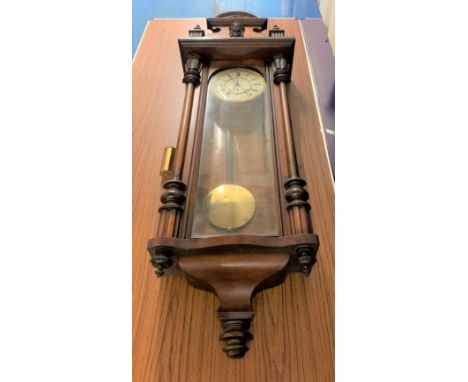 Mahogany Vienna style wall clock with enamel/brass face, with pendulum and single weight, 50”h x 17”w x 7”d