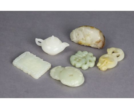 A Chinese carved white &amp; russet jade pebble, 3” x 1¾” (drilled forming a pendant); &amp; five other small white, pale gre