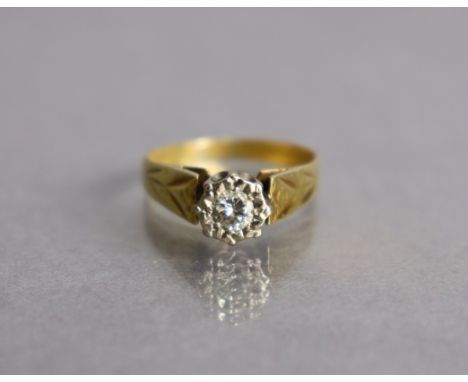 A yellow metal ring set single diamond of approx. 0.2ct, the engraved shank marked “18ct”, size J/K, 3.1g.