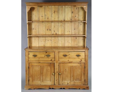 A Victorian pine dresser, with moulded cornice &amp; two open shelves above two deep frieze drawers with brass swan-neck hand