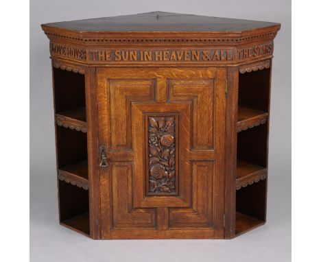 A well-made late 19th/early 20th century oak hanging corner cupboard, the dentil cornice with carved inscription in raised ca