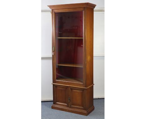 A late 19th/early 20th century mahogany narrow bookcase, converted from an “Army And Navy Makers C.S.L.” gun cabinet, with mo