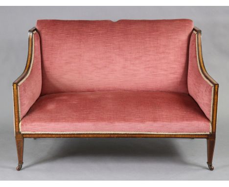 An Edwardian inlaid-mahogany framed two-seater sofa with square back &amp; down-swept arms, upholstered rose pink velour, on 