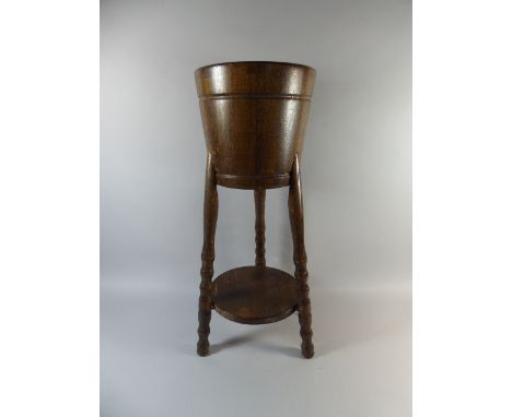 An Edwardian Oak Planter on Tripod Support with Circular Stretcher Shelf, 70cm High 