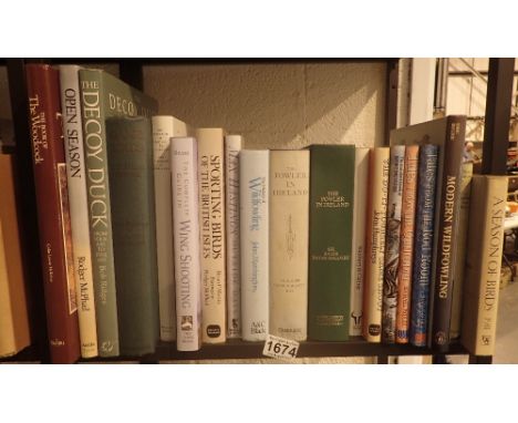 Shelf of hunting books including Wildfowling