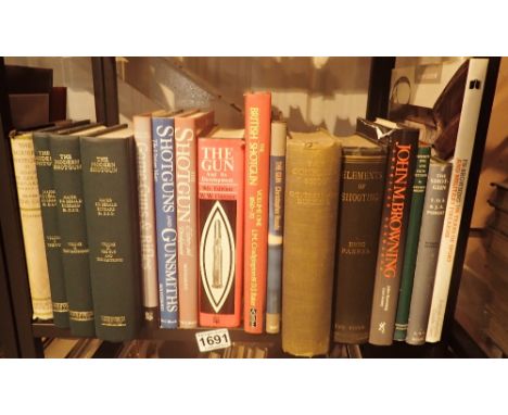 Shelf of books on shooting and guns