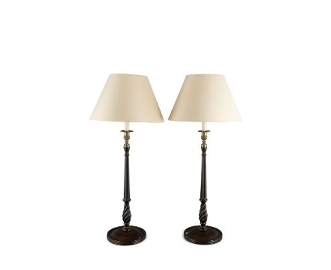 A PAIR OF SLENDER TURNED STAINED WOOD TABLE LAMPS, the facetted tapering columns raised on circular spreading bases. 62cm hig