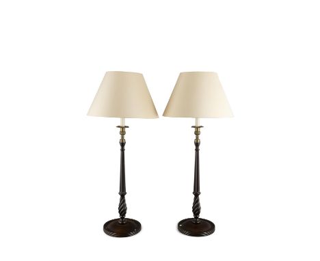 A PAIR OF SLENDER TURNED STAINED WOOD TABLE LAMPS, the facetted tapering columns raised on circular spreading bases. 62cm hig