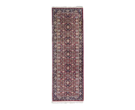 A SEMI-ANTIQUE TURKISH WOOL RUNNER, 250 x 78.5cmthe central field filled with small flower heads in light blue, pink and yell