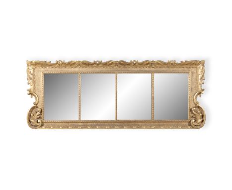 AN IRISH GEORGE III GILTWOOD COMPARTMENTAL MIRROR, of oblong shape fitted with four bevelled glass plates within a border of 