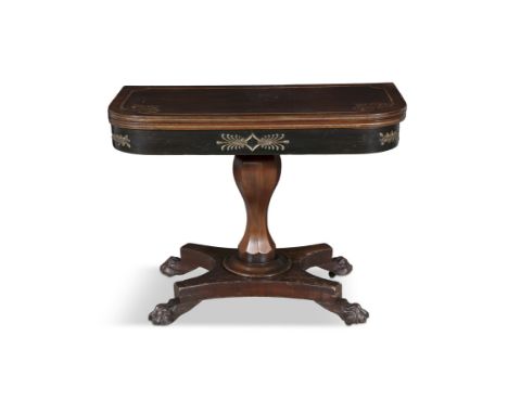 A REGENCY AND EBONISED AND GILT DECORATED FOLD-OVER GAMES TABLE the top with scrollwork carving, over frieze centred with bra