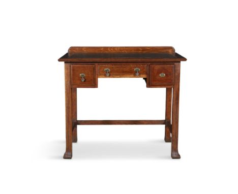 AN ARTS AND CRAFTS OAK WRITING TABLE, C. 1900, the rectangular top with green and gilt tooled scriver over knee-hole space an