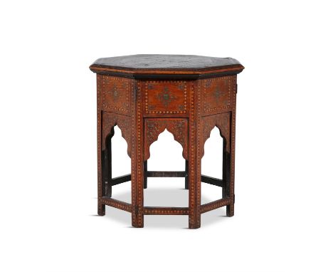 AN INDIAN HARDWOOD AND BRASS INLAID OCTAGONAL TABLE C.1900profusely decorated with leaf scrolls on a collapsible stand. 49cm 