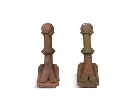 A PAIR OF TERRACOTTA ROOF FINIALS,each with knopped pillar supporting a spherical top, on splayed base. Each 79cm high