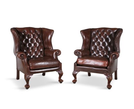 A PAIR OF RED WINGBACK UPHOLSTERED ARMCHAIRS 20TH CENTURYcovered in a button back hide, with brass studding with loose seat c