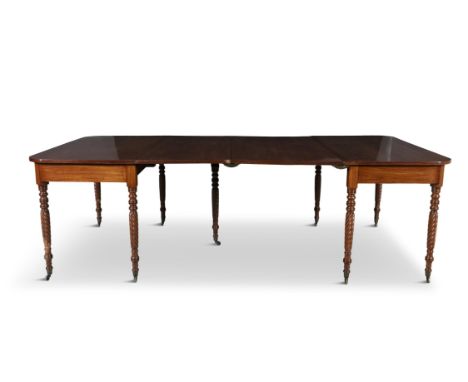 AN IRISH GEORGE IV MAHOGANY EXTENDING DINING TABLE, the figured rectangular top with rounded corners over a plain frieze and 