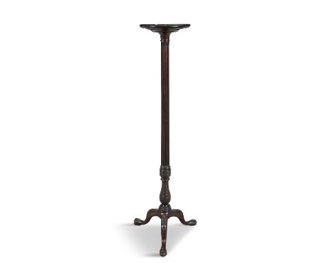 A GEORGE III STYLE MAHOGANY TORCHÈRE STAND,with circular top, raised on a fluted pillar and tripod base and paw feet, 152cm h