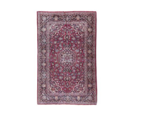 A FINE KASHAN WOOL CARPET. 212 x 130CMthe central field woven with a large flowerhead medallion in red, pink, navy, and green