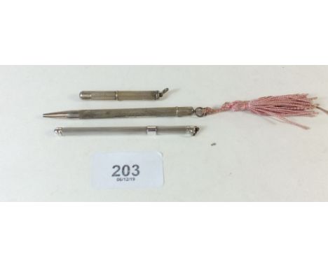 A box containing silver toothpick, pencil and swizzle stick