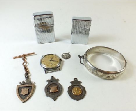 A silver bangle, two silver medals, a silver plated medal with gold fob, a Pacific vintage man's watch and two cigarette ligh