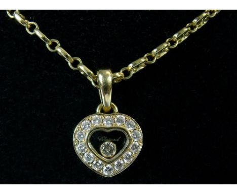 A Chopard 18 carat gold Happy Diamonds pendant with diamond set heart enclosing single loose diamond, on 18 carat gold chain,