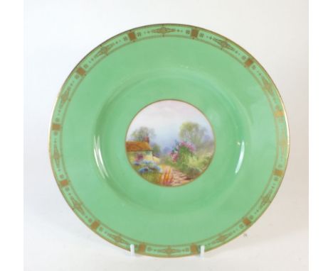 A Royal Worcester plate painted cottage and garden scene on an apple green ground signed Rushton, 26cm