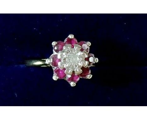 An 18 carat gold ruby and diamond cluster ring - size J 1/2