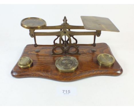 A set of late 19th century brass postal scales on wooden base with weights