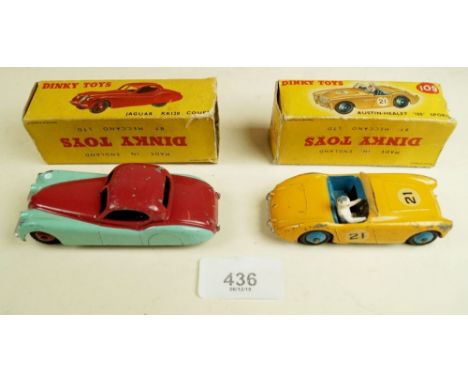 A Dinky die cast red Jaguar coupe XK120  (157) and a yellow Austin Healey Sports 100 (109)