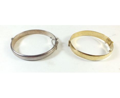 A rolled gold bangle and silver bangle