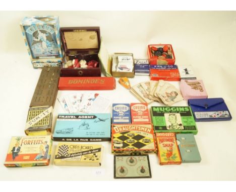 A box of early to mid 20th century playing cards and various travel games