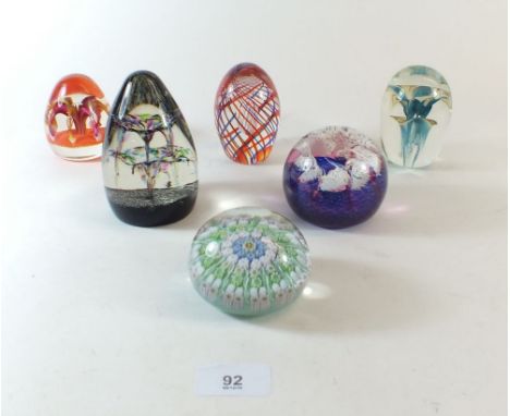 Six various glass paperweights including Caithness, Blue Splash and Concorde