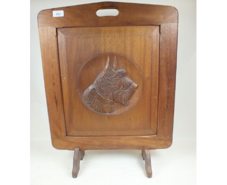 A 1930's wooden firescreen carved Scottie dog