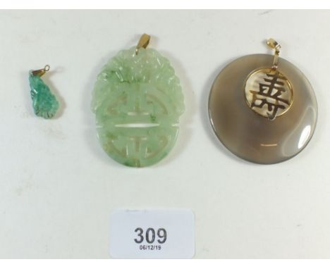 Two large jade pendants and a smaller one