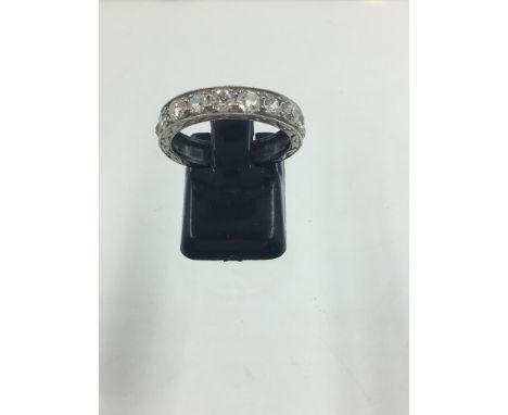 A PRECIOUS WHITE METAL 10 STONE OLD CUT BEAD AND BRIGHT SET DIAMOND FLORAL ENGRAVED HALF ETERNITY RING, FINGER SIZE M 1/2, AP