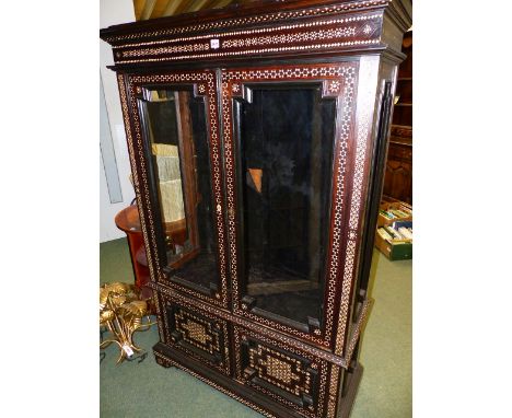 AN ANTIQUE CONTINENTAL INLAID DISPLAY CABINET OF SPANISH/ MOROCCAN DESIGN.  GLAZED UPPER SECTION ABOVE TWO DOOR CUPBOARD, BRA