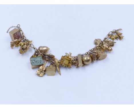 A 9ct YELLOW GOLD CHARM BRACELET COMPLETE WITH VARIOUS CHARMS TO INCLUDE A ROMANY WAGON, GOLF CLUBS,A MOVING TRACTOR, ETC.   